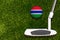 A golf club and a ball with flag Gambia during a golf game