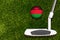 A golf club and a ball with flag Malawi during a golf game