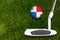 A golf club and a ball with flag Panama during a golf game