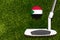 A golf club and a ball with flag Sudan during a golf game