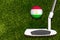 A golf club and a ball with flag Tajikistan during a golf game