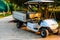 Golf Club Car on the street. The electric golf car with cargo luggage suitable for a short trip, moving people, transporting parts