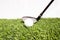 A golf club that is played by people hitting a golf ball on an artificial grass. Green means being ready for the game of golf