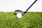 A golf club that is played by people hitting a golf ball on an artificial grass. Green means being ready for the game of golf