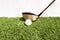 A golf club that is played by people hitting a golf ball on an artificial grass. Green means being ready for the game of golf