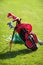 Golf clubs in golfbag, green grass background