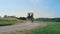 Golf couple driving cart on fairway. Players team ride buggy car on summer day.