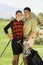 Golf Couple Standing Together On Course