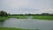 Golf course amidst water, natural landscape. Wide footage