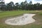 Golf course bunker/ sand trap on a golf course sourrounded by trees