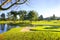 Golf course with green grass, sand bunker and pond