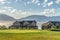 Golf course homes lake distant mountain and cloudy sky viewed on a sunny day