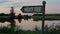 Golf course tee sign in empty golfing park. Show direction on sunset nature lake