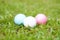 Golf crystal white, pink, and blue ball on green grass in golf course