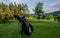 Golf equipment at the course on sunny day. Golf bag on the fairway