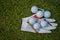 Golf equipment on green grass, ball, glove, tee and golf-club driver, golf gear and equipment on flat lay top view