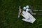 Golf equipment on green grass, ball, glove, tee and golf-club driver, golf gear and equipment on flat lay top view