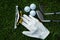 Golf equipment on green grass, ball, glove, tee and golf-club driver, golf gear and equipment on flat lay top view