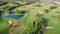 Golf field. Green golf course with small lake and trees. Relax time, sport concept. Recreation leisure activity. Golf club with go
