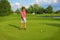 Golf, girl golfer driving ball into the hole