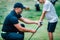 Golf Instructor adjusting young boyâ€™s grip