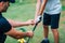 Golf Instructor adjusting young boyâ€™s grip