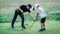 Golf Lessons. A golf Instructor and a boy practicing on a Golf Practice Range