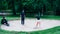 Golf lessons â€“ Young woman having a golf lesson, playing from sand bunker