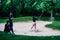 Golf lessons â€“ Young woman having a golf lesson, playing from sand bunker