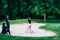 Golf lessons â€“ Young woman having a golf lesson, playing from sand bunker