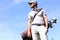 Golf player walking and carrying bag on course during summer game golfing