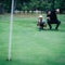 Golf Putting Training. Golf Instructor with Young Boy Practicing on the Putting Green