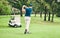 Golf, stroke and grass with a sports man swinging a club on a field or course for recreation and fun. Golfing, hobby and