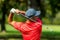 Golf swing rear view. Professional golfer finishing a golf swing