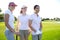 Golf three woman in a row green grass course