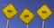 Golf - three yellow signs with blue sky background