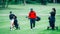 Golf training. Two young ladies with golf instructor having a lesson on a golf course