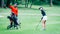 Golf training. Two young ladies with golf instructor having a lesson on a golf course