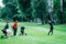 Golf training. Two young ladies with golf instructor having a lesson on a golf course