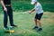 Golf â€“ Personal Training. Golf Instructor Teaching Young Boy How to Play Golf