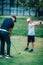 Golf â€“ Personal Training. Golf Instructor Teaching Young Boy How to Play Golf