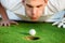 Golfer blowing in the ball