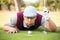 Golfer blowing ball in the hole