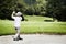 Golfer chipping in bunker.