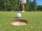 Golfer drove ball into hole and golf course