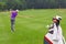 Golfer fairway iron shot ball mid air