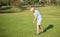 golfer full length in cap with golf club, summer