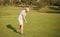 golfer full length in cap with golf club, summer