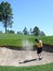 Golfer hitting out of a sand trap