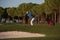 Golfer hitting a sand bunker shot on sunset